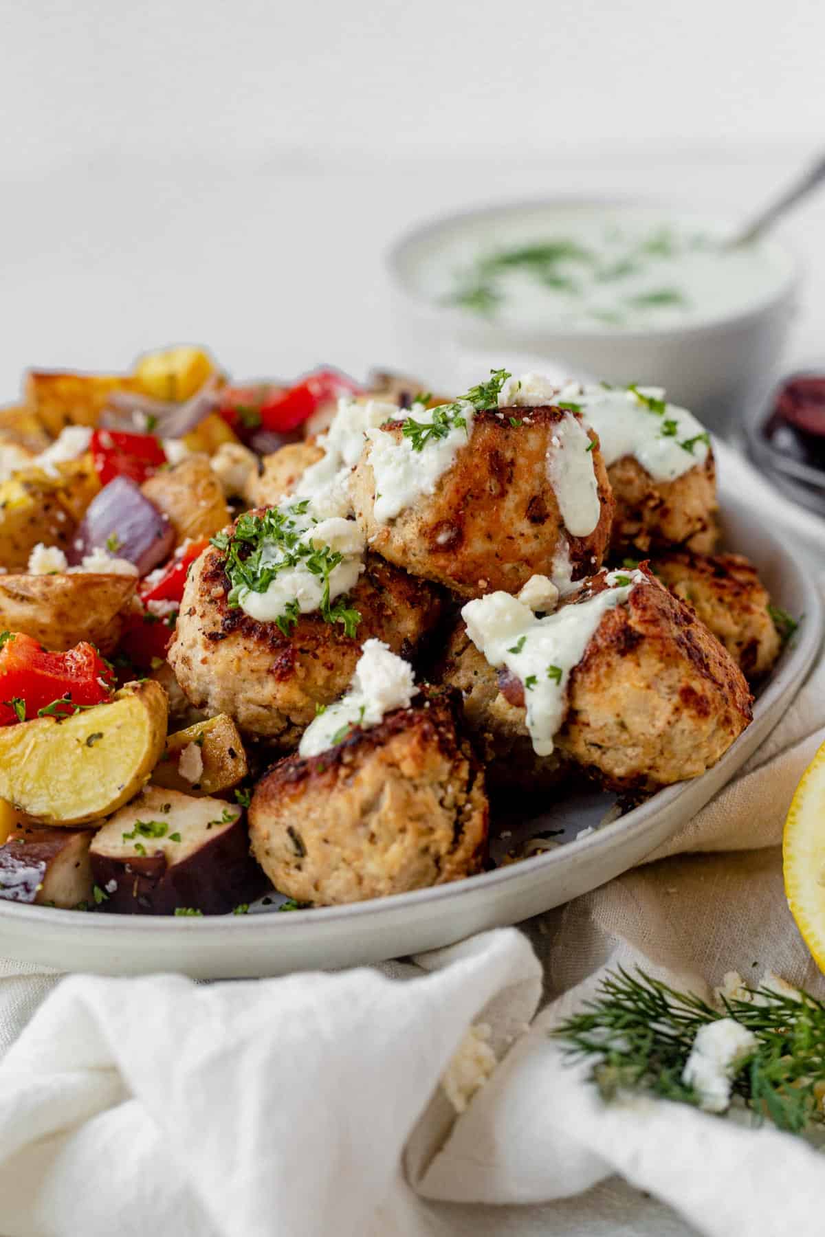 greek chicken meatballs with tzatziki sauce and roasted vegetables