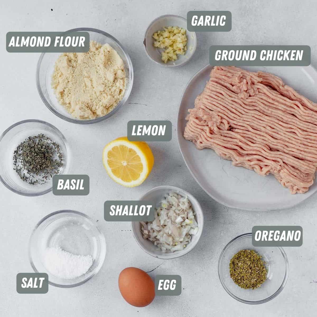 ingredients for greek chicken meatballs measured on a table