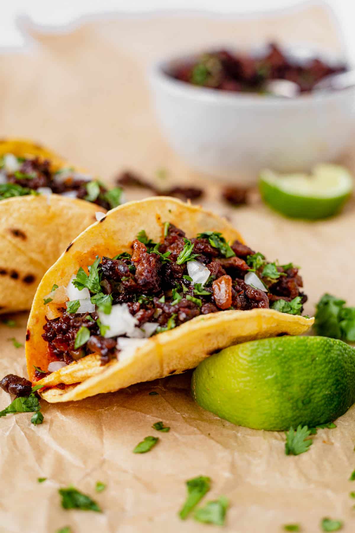 two mexican chorizo tacos in corn tortillas with cilantro and onion