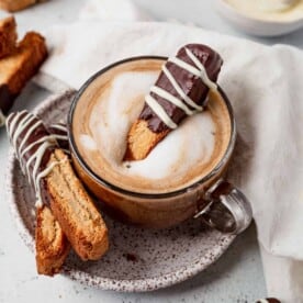 gluten free biscotti on a plate with a cup of coffee