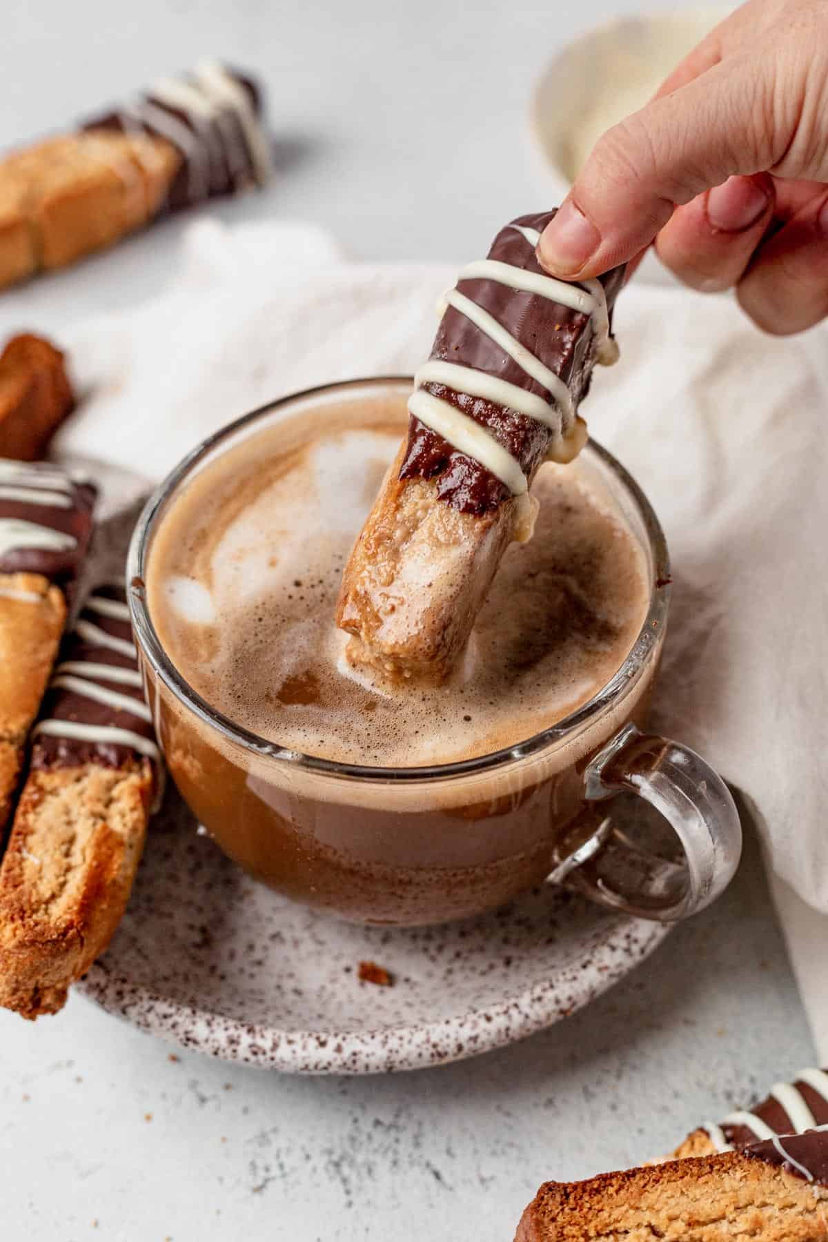 dipping gluten free biscotti into a cup of coffee