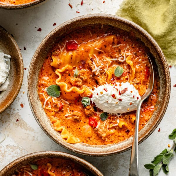 a bowl of instant pot lasagna soup with ricotta on top.