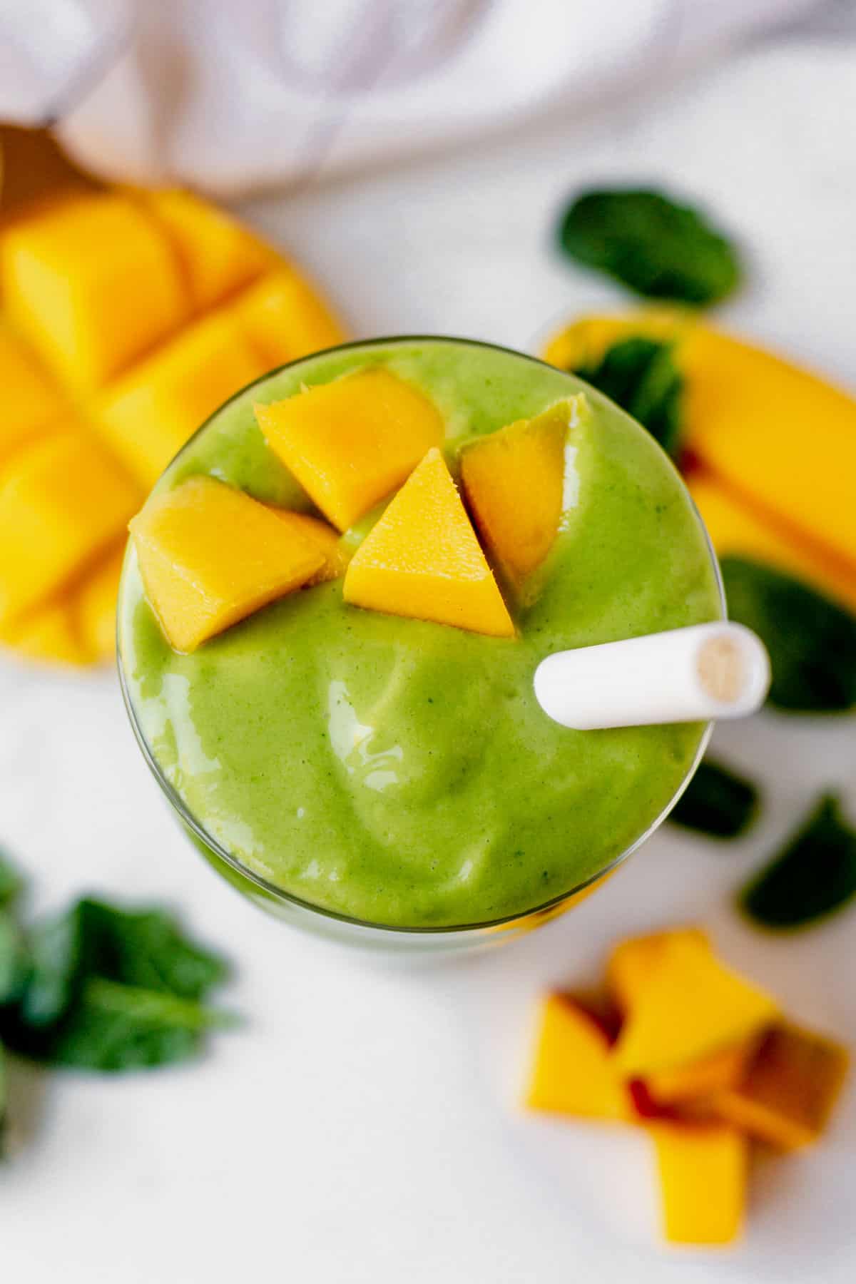 the top of a creamy spinach mango smoothie 