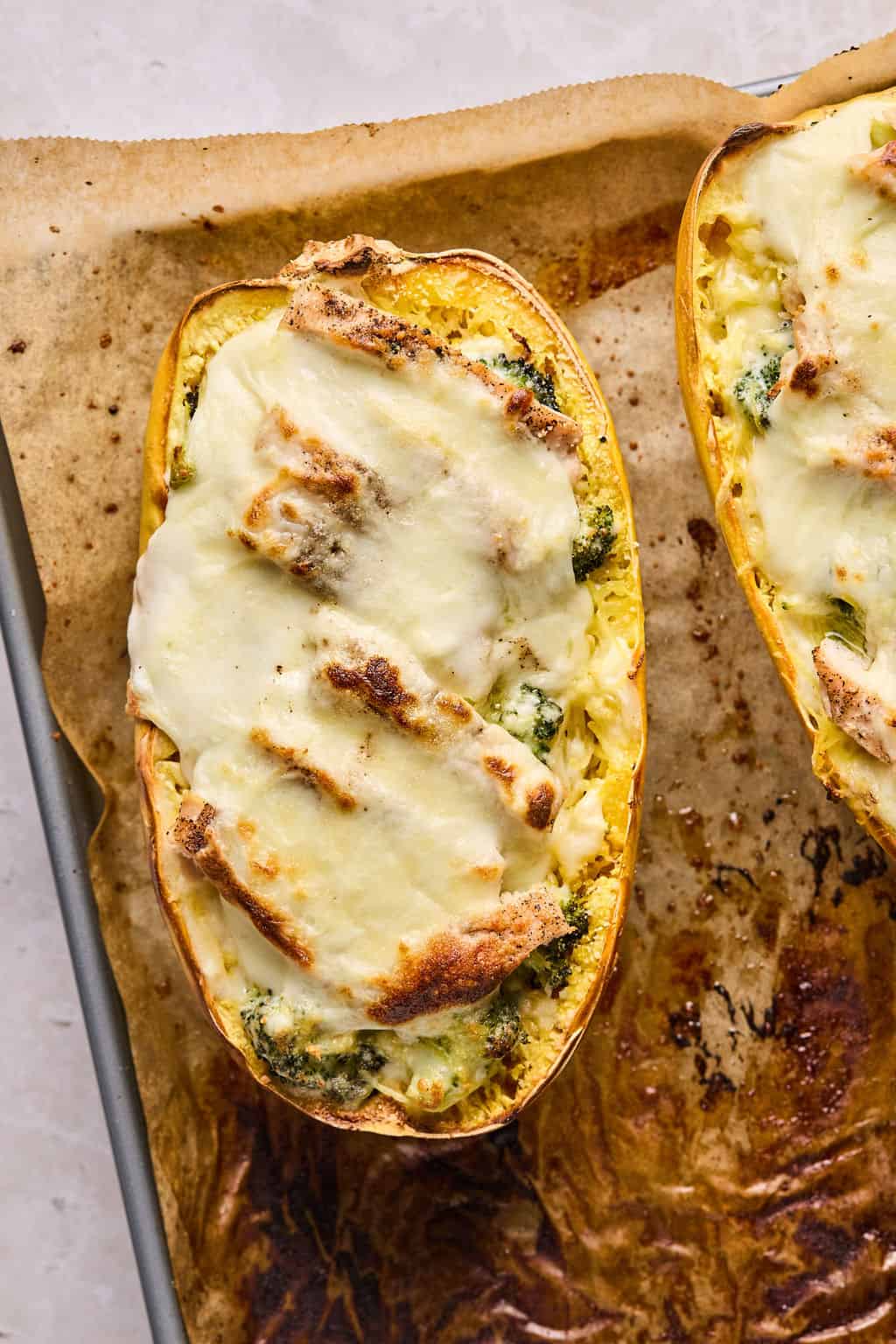 baked chicken alfredo spaghetti squash on a sheet pan.