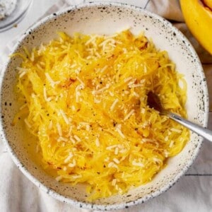 air fryer spaghetti squash on a white plate with a fork