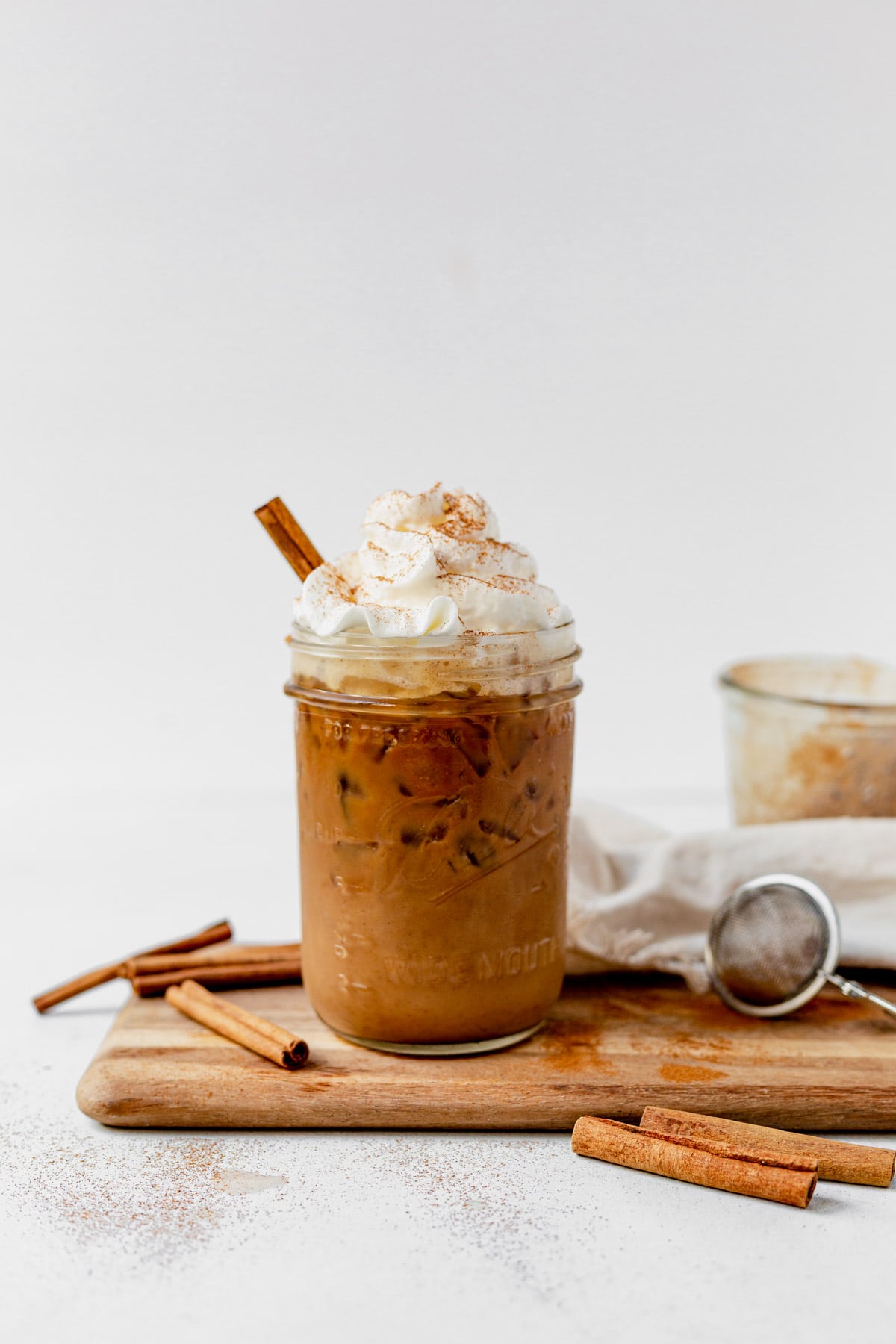 copycat iced cinnamon dolce latte with whipped cream and cinnamon