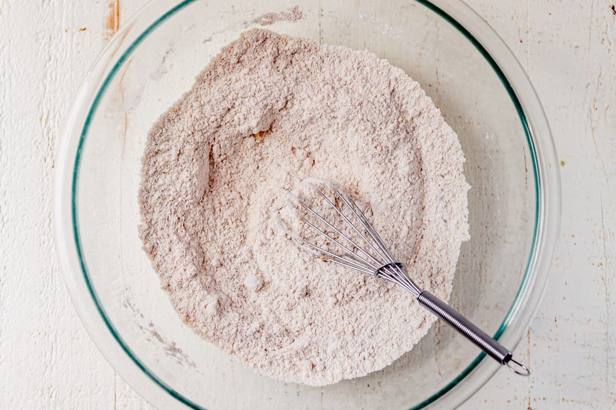flour, baking soda, baking powder, salt, and cinnamon mixed in a bowl