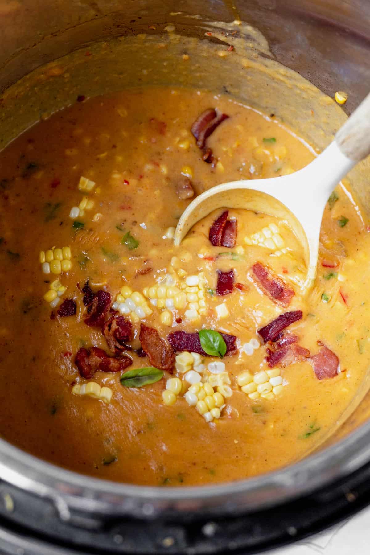 scooping corn chowder out of the instant pot