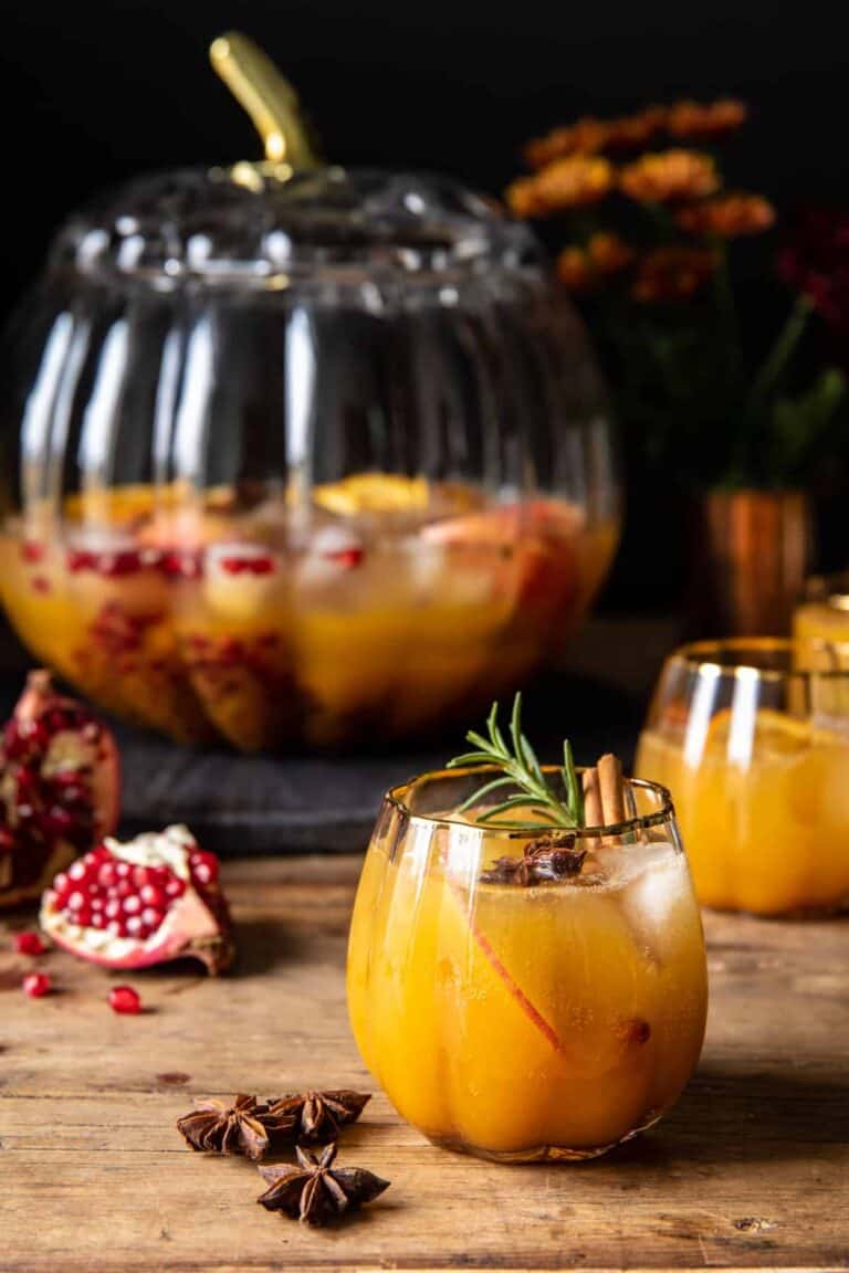 a pitcher of pumpkin punch with a glass served next to it