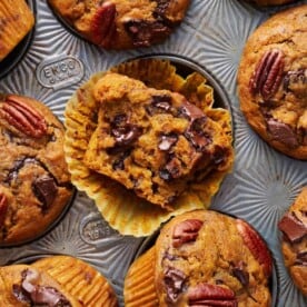 baked pumpkin muffins with chocolate chips in a muffin tin