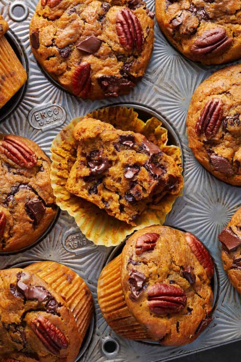 baked pumpkin muffins with chocolate chips in a muffin tin