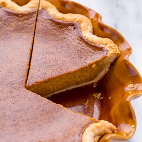 a slice of pumpkin pie in a pie dish