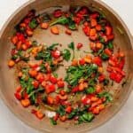 sauted peppers and spinach in a pan