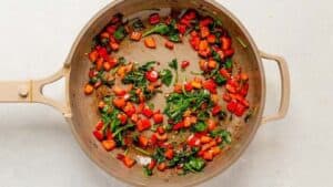 sauted peppers and spinach in a pan