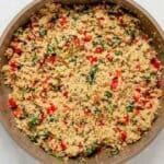cooked quinoa, peppers and spinach in a pan