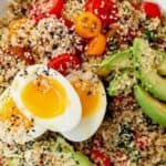 quinoa, eggs, tomatoes and avocado in a bowl