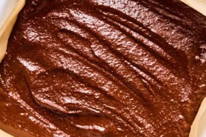 chocolate potato cake batter spread into a baking pan.