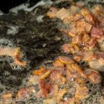 cooked bacon bits in a skillet