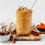 pumpkin spice overnight oats in a mason jar topped with pecans
