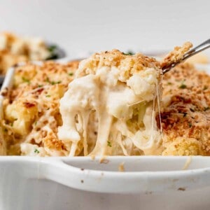 cheesy cauliflower gratin coming out of the casserole dish