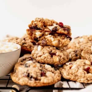 white chocolate cranberry oatmeal cookies stacked on a wire rack