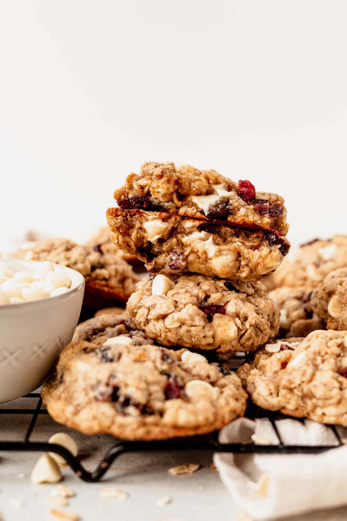 white chocolate cranberry oatmeal cookies stacking on a wire cooling rack