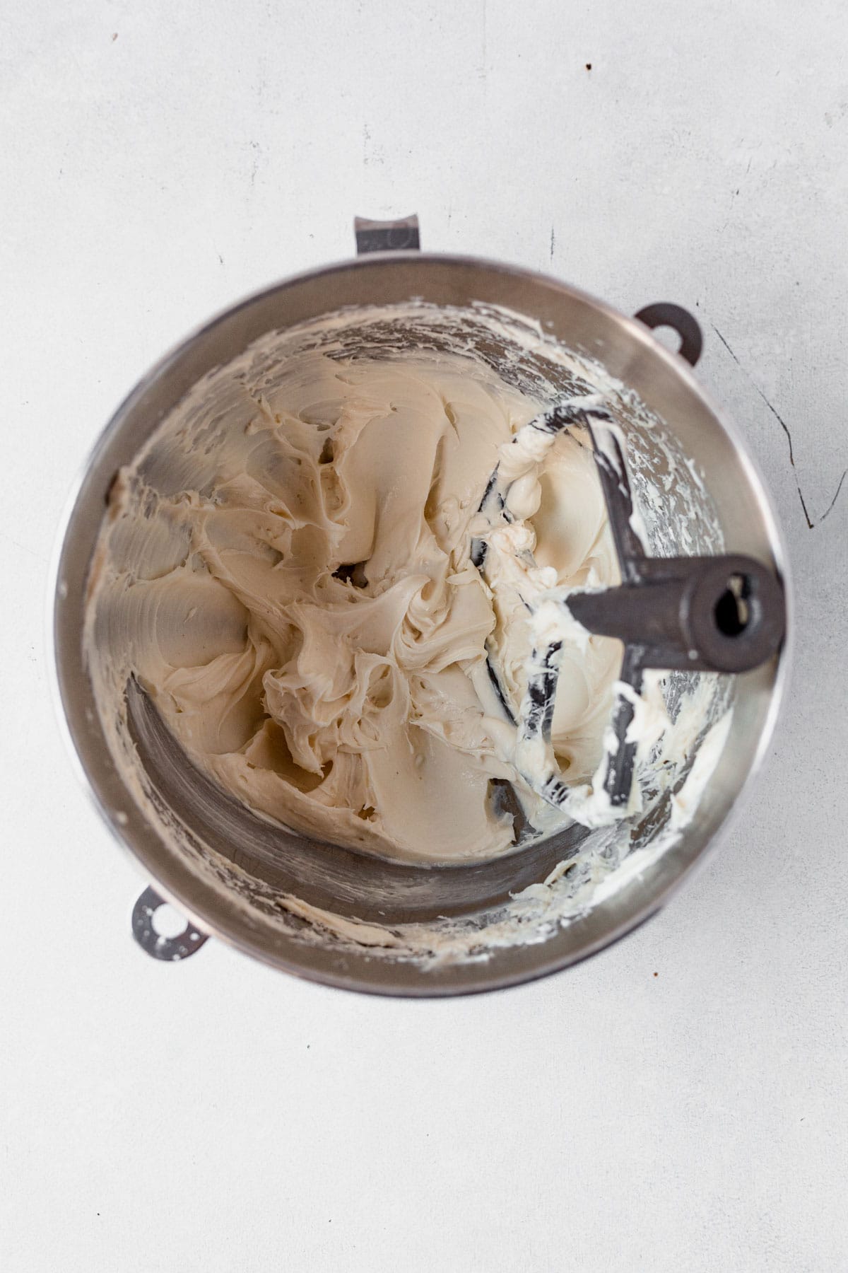 frosting for caramel cheesecake cookies mixed in a bowl with the paddle attachment.
