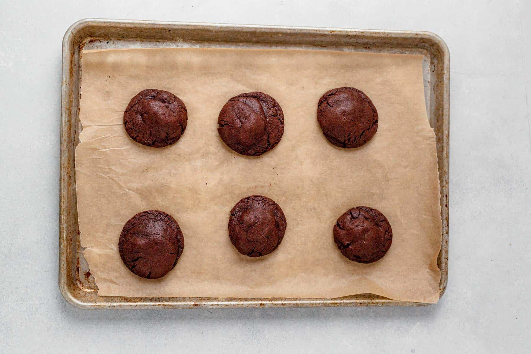 6 baked rolo cookies on a cookie sheet