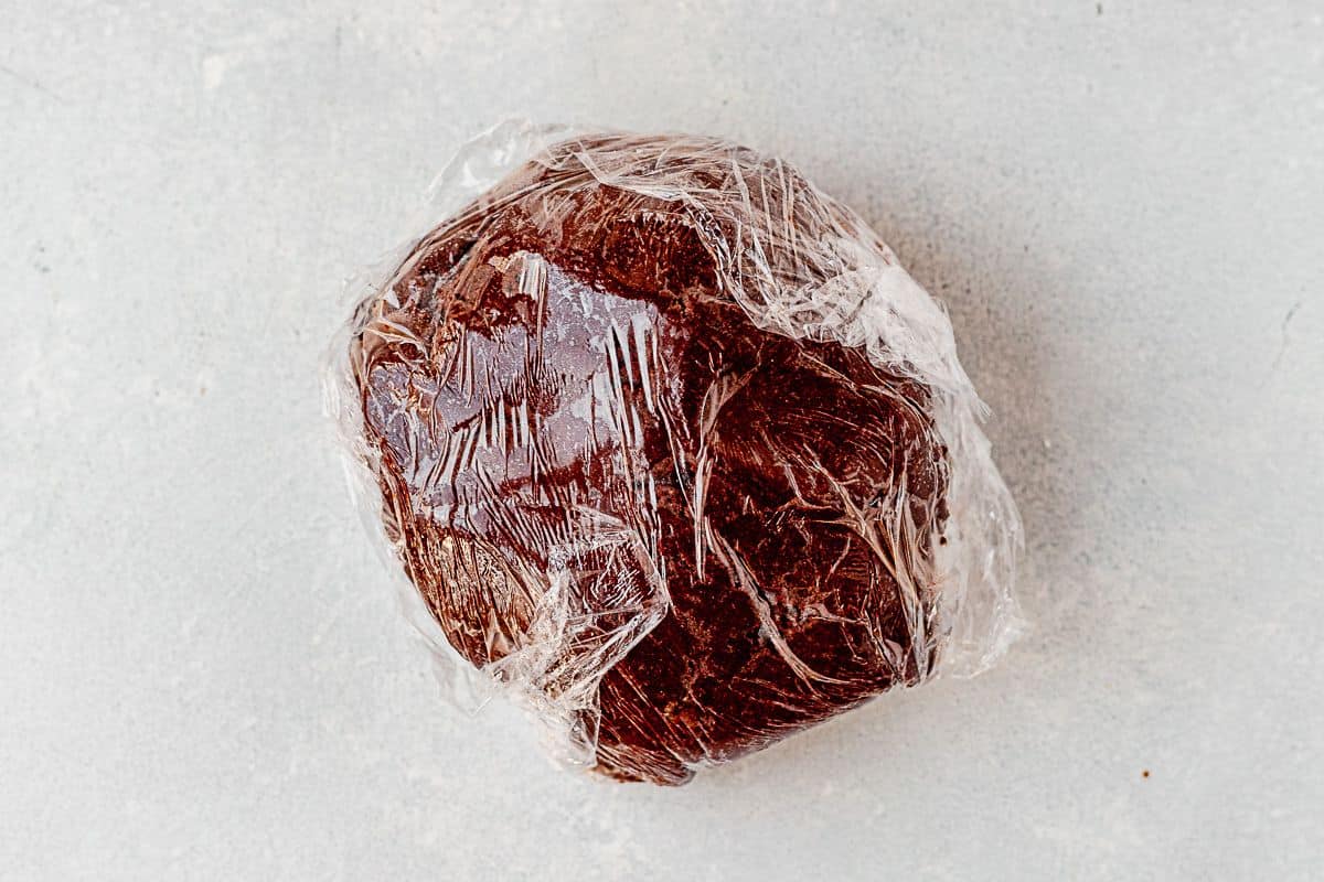 chocolate shortbread cookie dough wrapped in plastic wrap