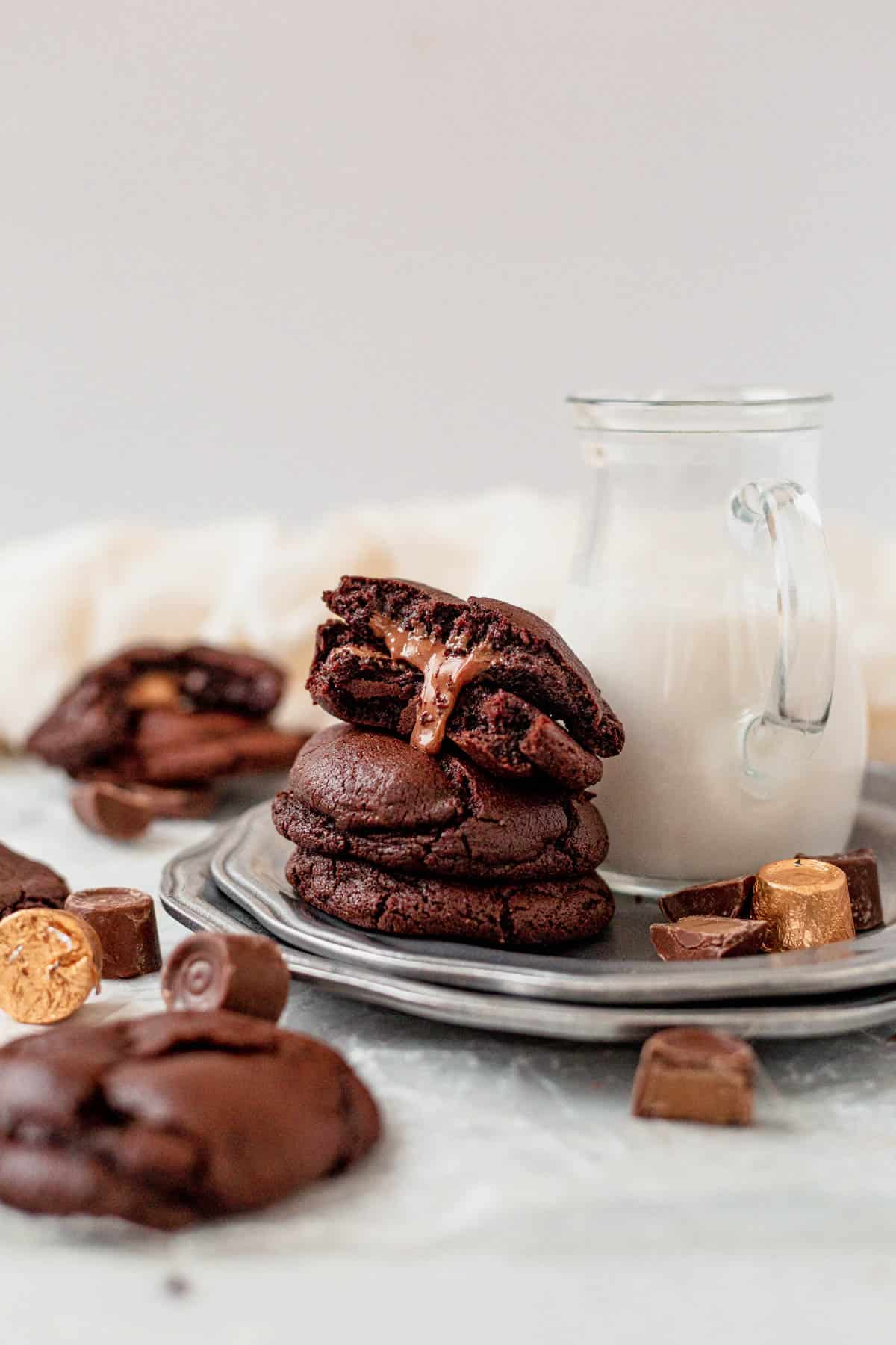 a stack of rolo cookies with chocolate dripping out of the center of one