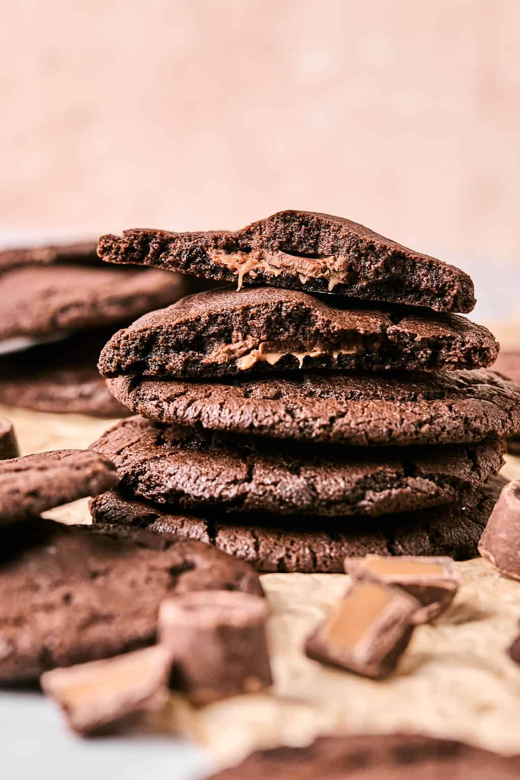 a stack of rolo cookies with the top one broken in half.