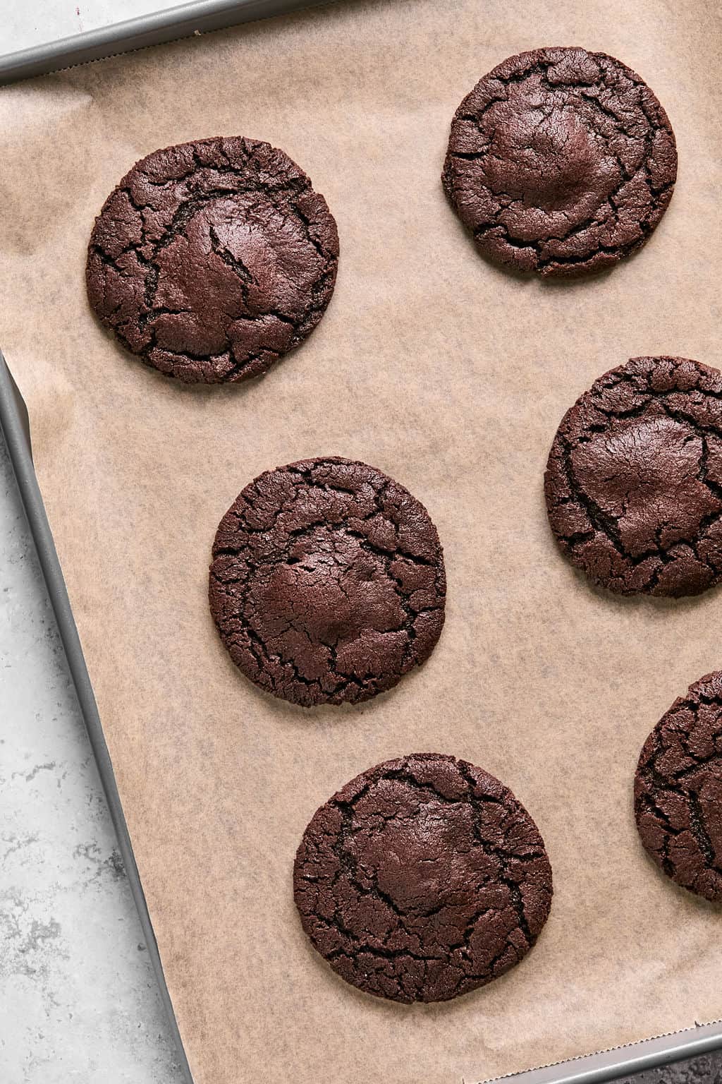 baked rolor cookies cooling on a baking sheet.