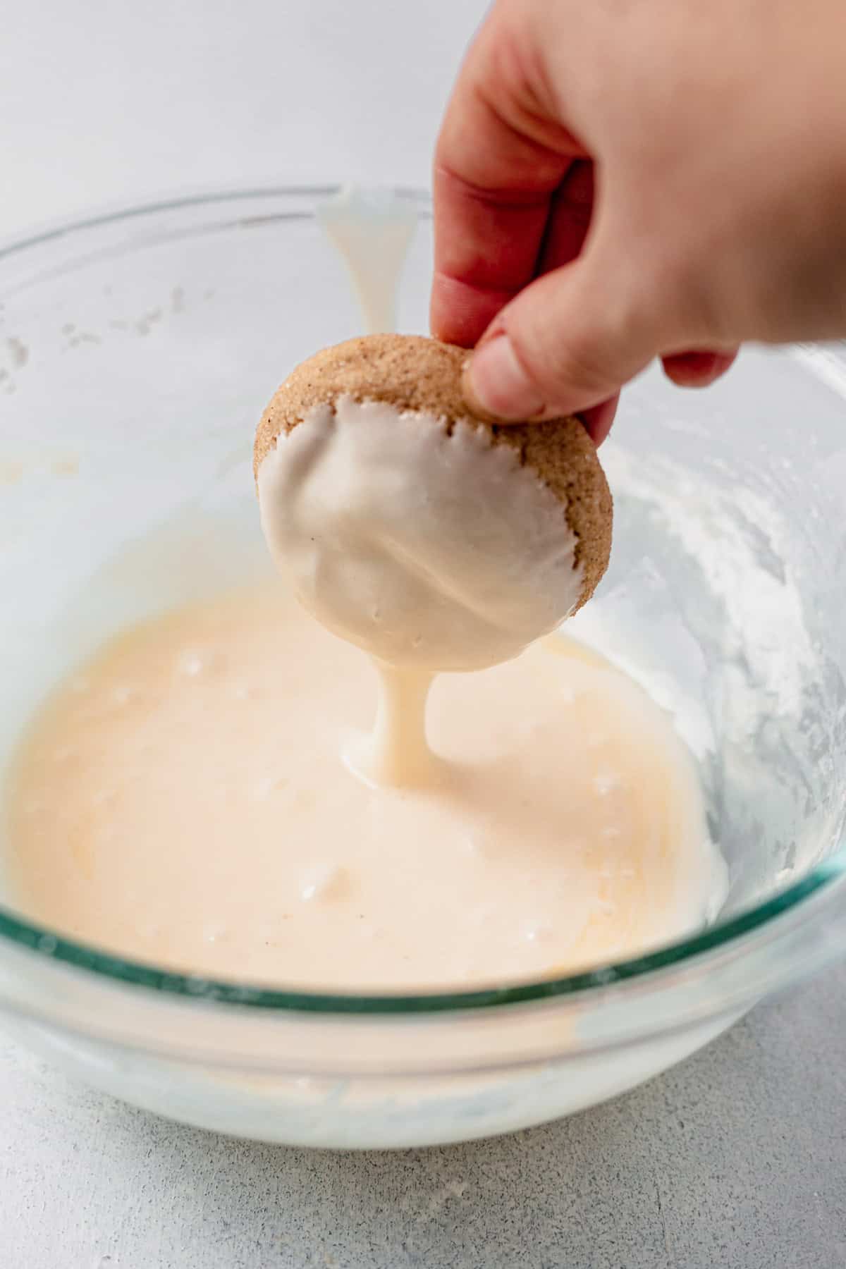 dipping a chai cookie in eggnog icing.