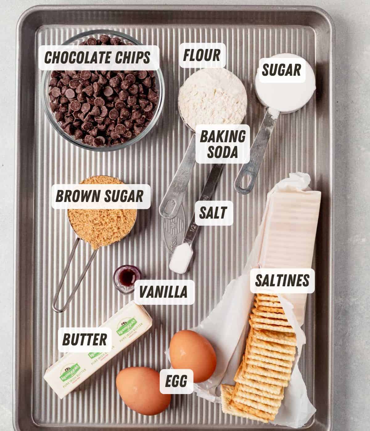 chocolate chips, brown sugar, flour, eggs saltine crackers, sugar and baking soda on a cookie sheet