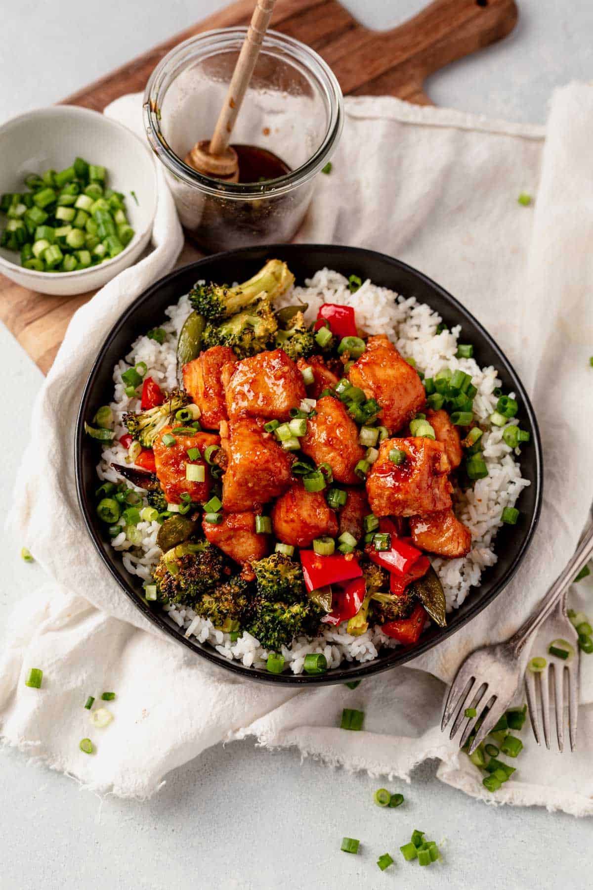 a bowl of rice with cooked veggies and air fryer salmon bites