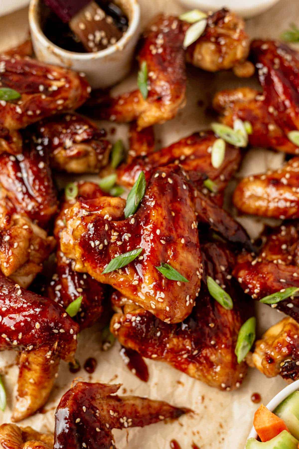 baked chicken wings served with asian sauce and green onion