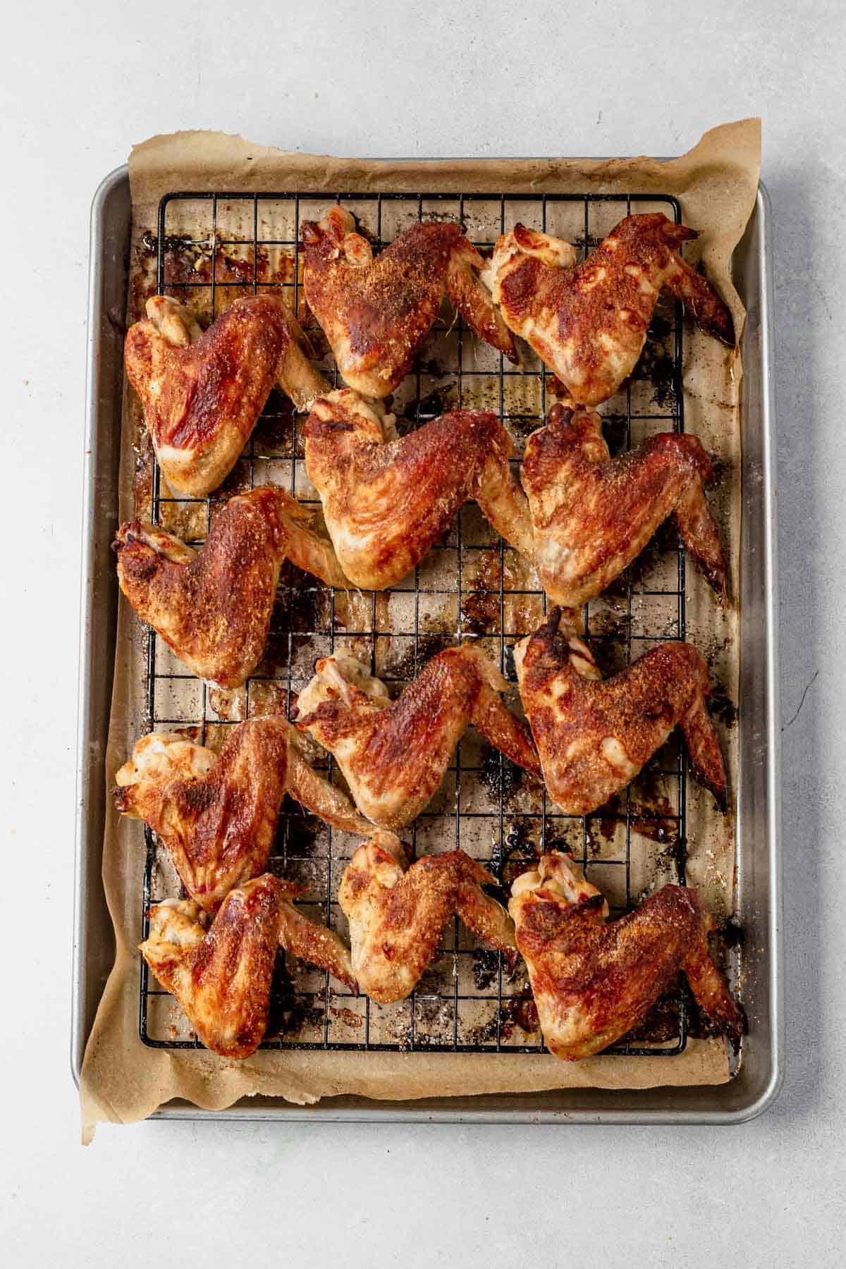 crispy baked chicken wings on a wire rack and baking sheet