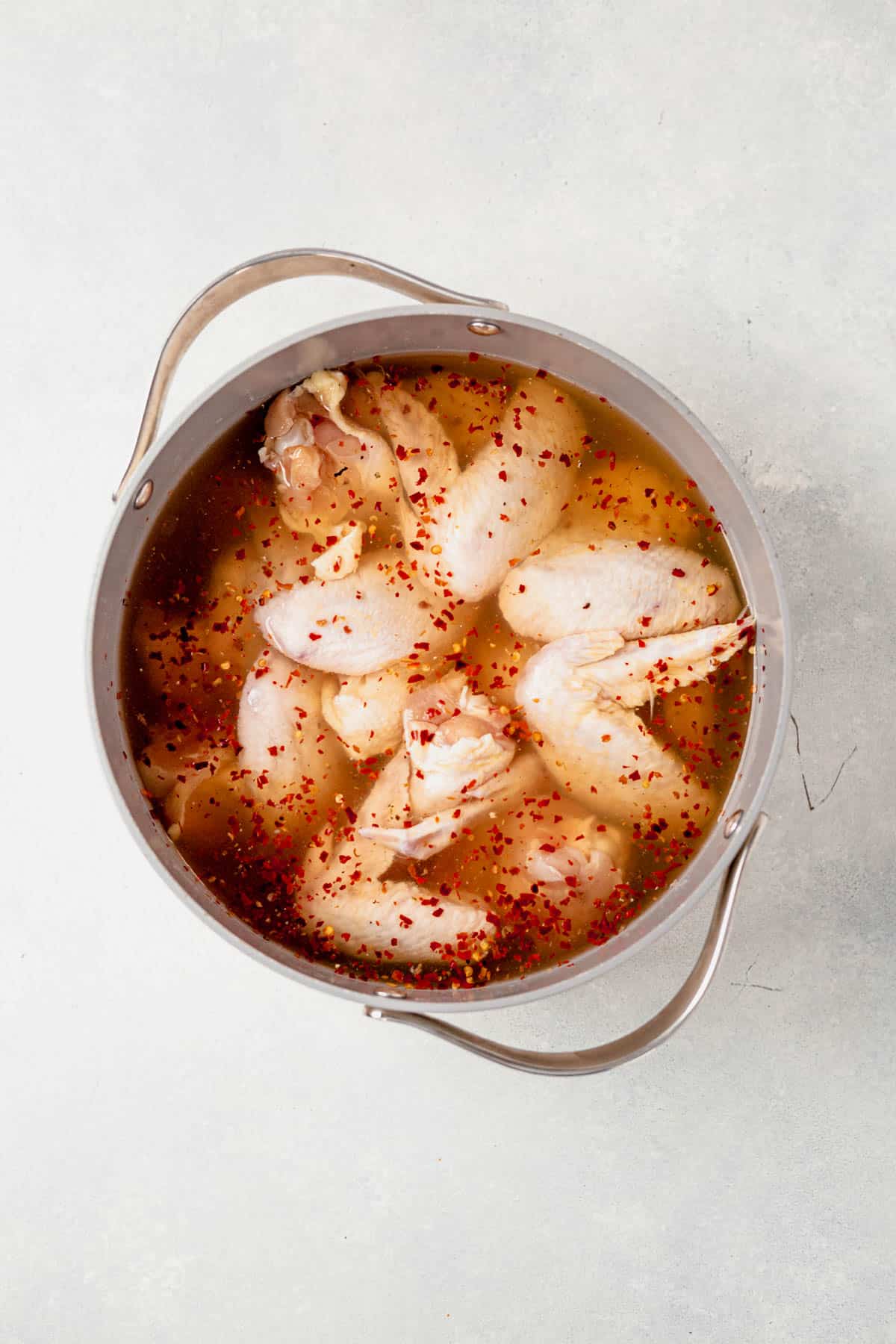 chicken wings brining in a large pot