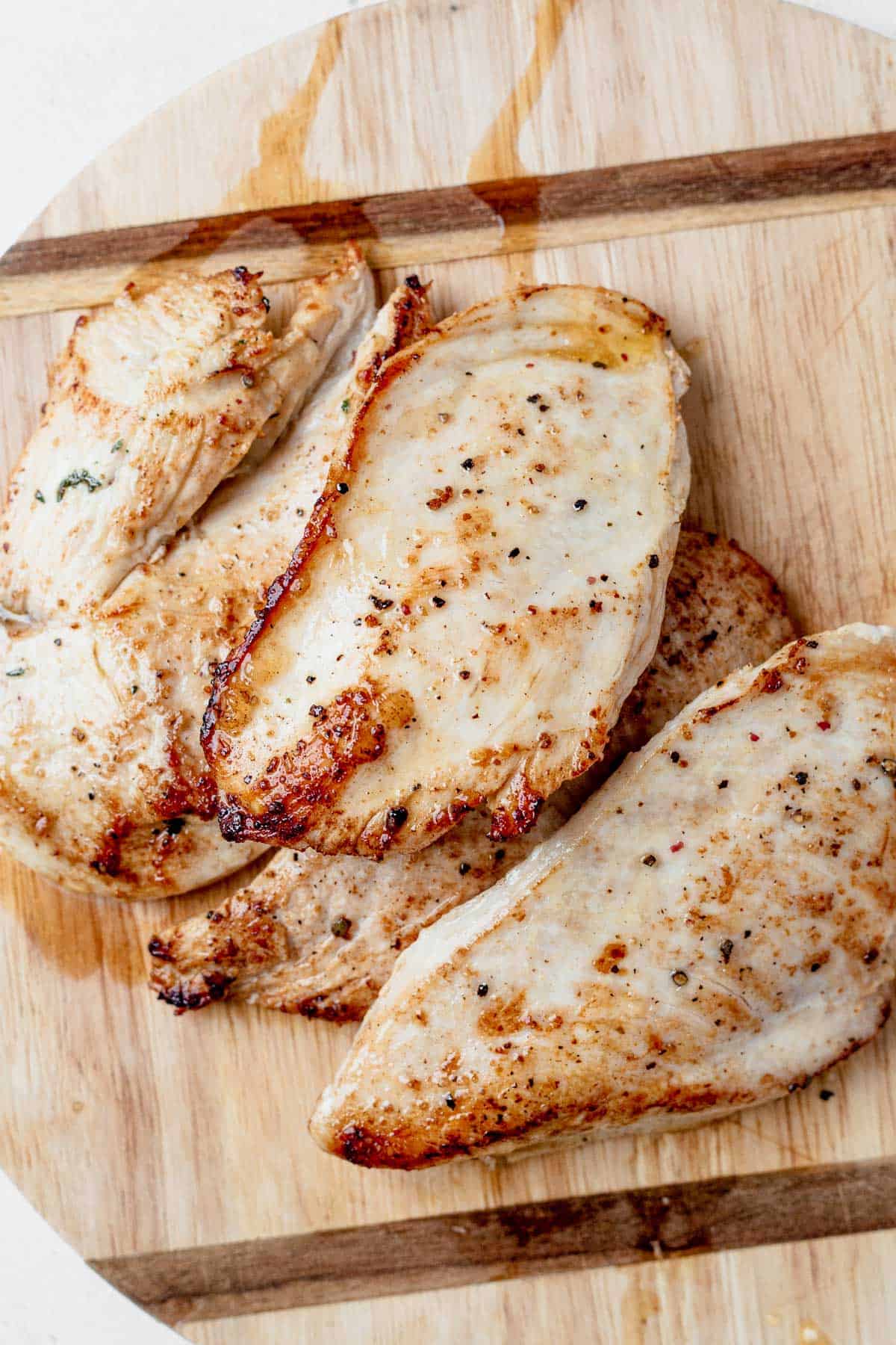 crispy seared chicken breast on a cutting board