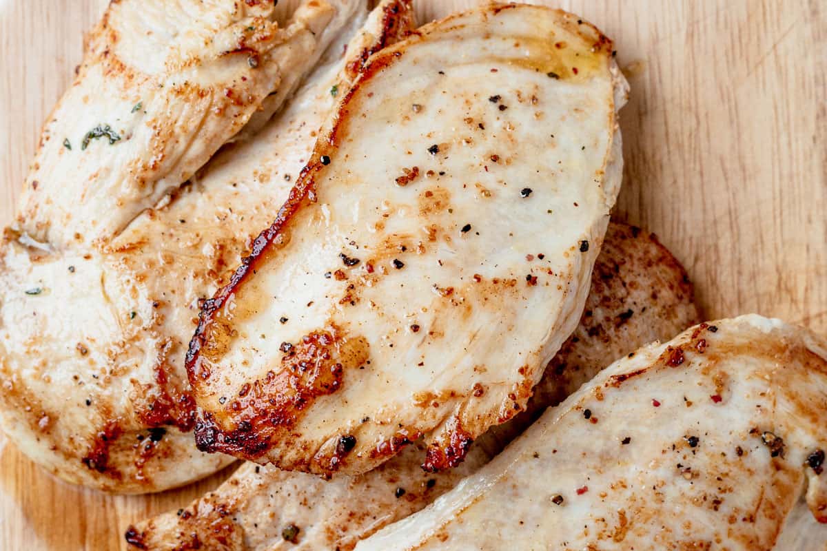 crispy seared chicken breast on a cutting board