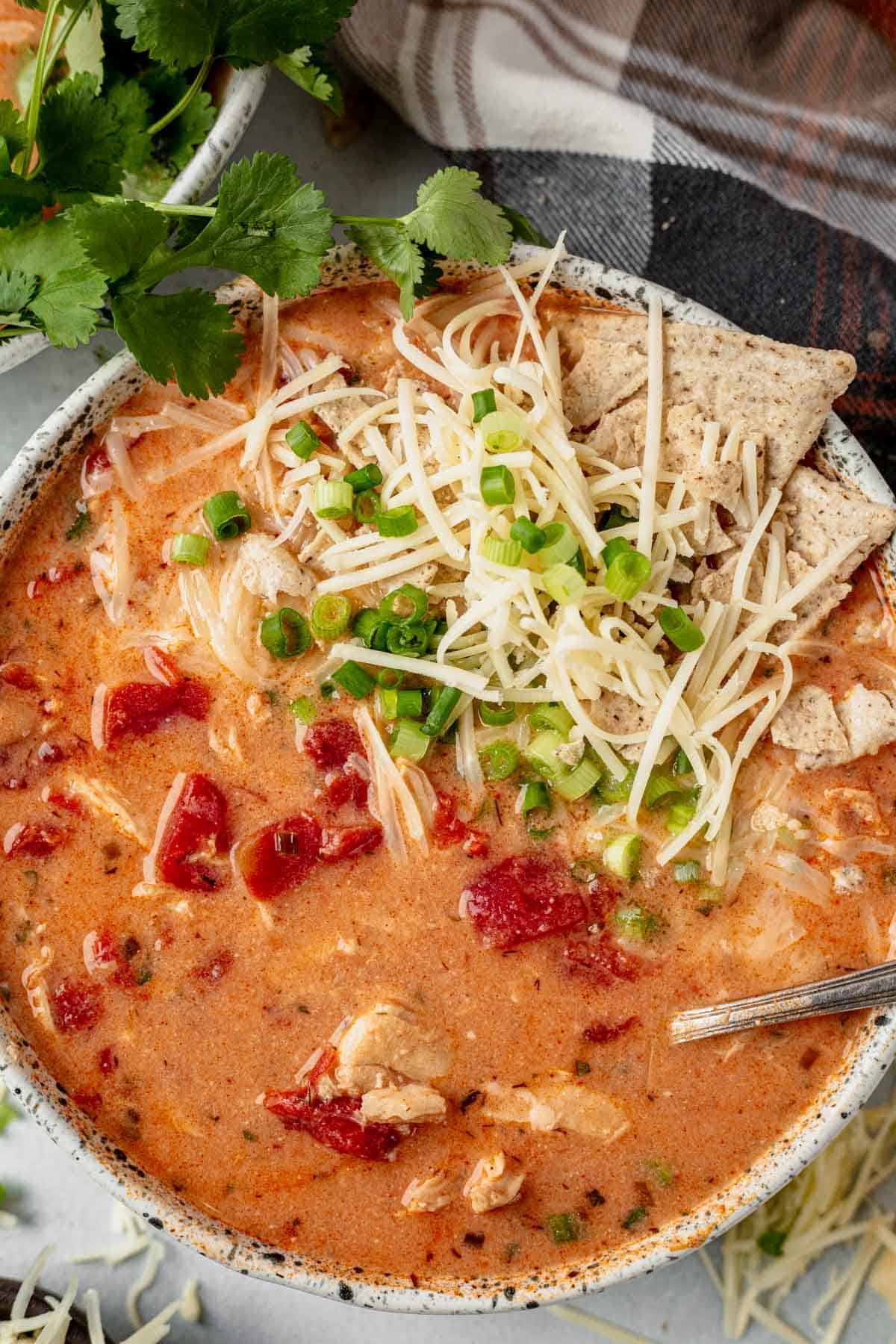 creamy buffalo chicken chili with a spoon for serving