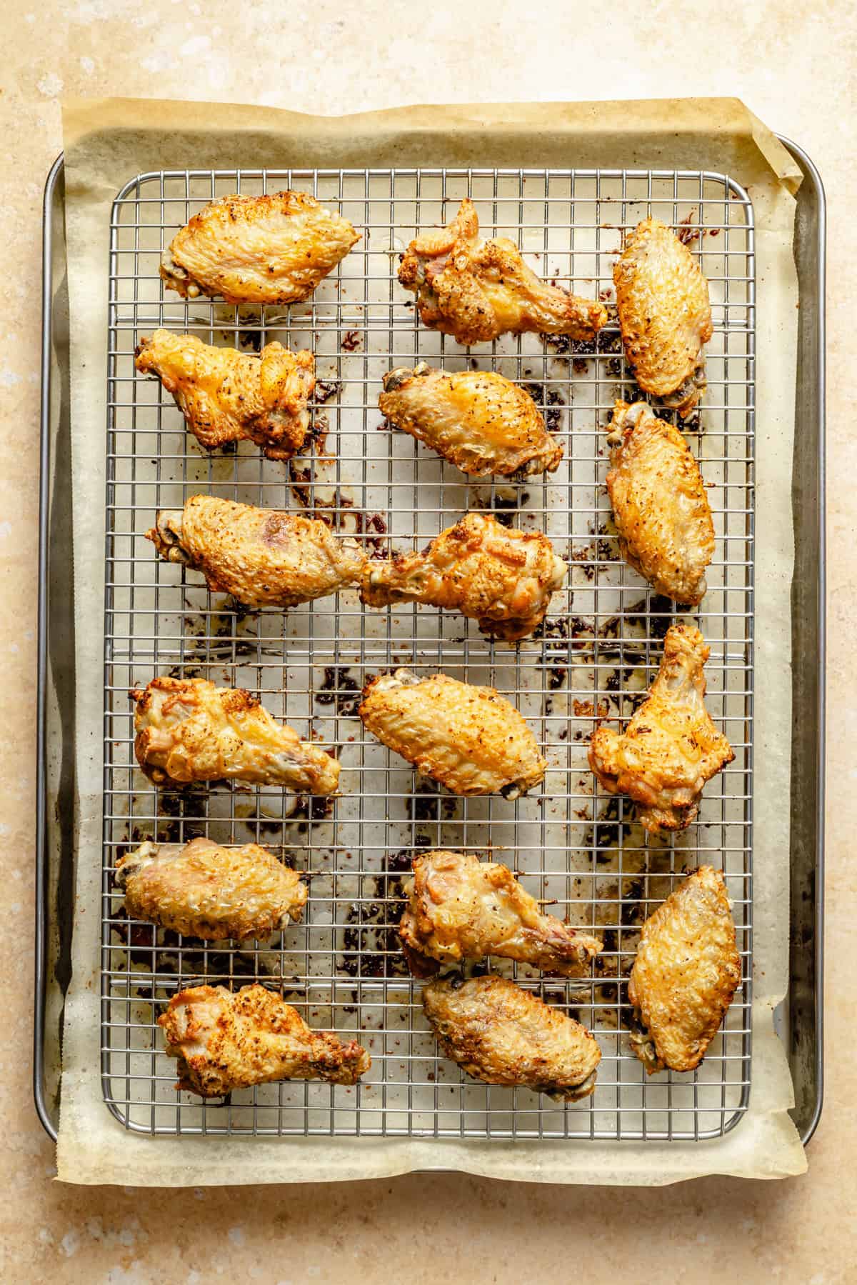 crispy baked chicken wings on a wire rack on a sheet pan.