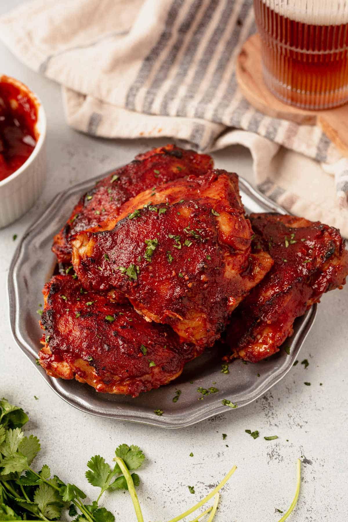 baked bbq chicken thighs with a glass of beer