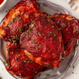 a plate of baked bbq chicken thighs