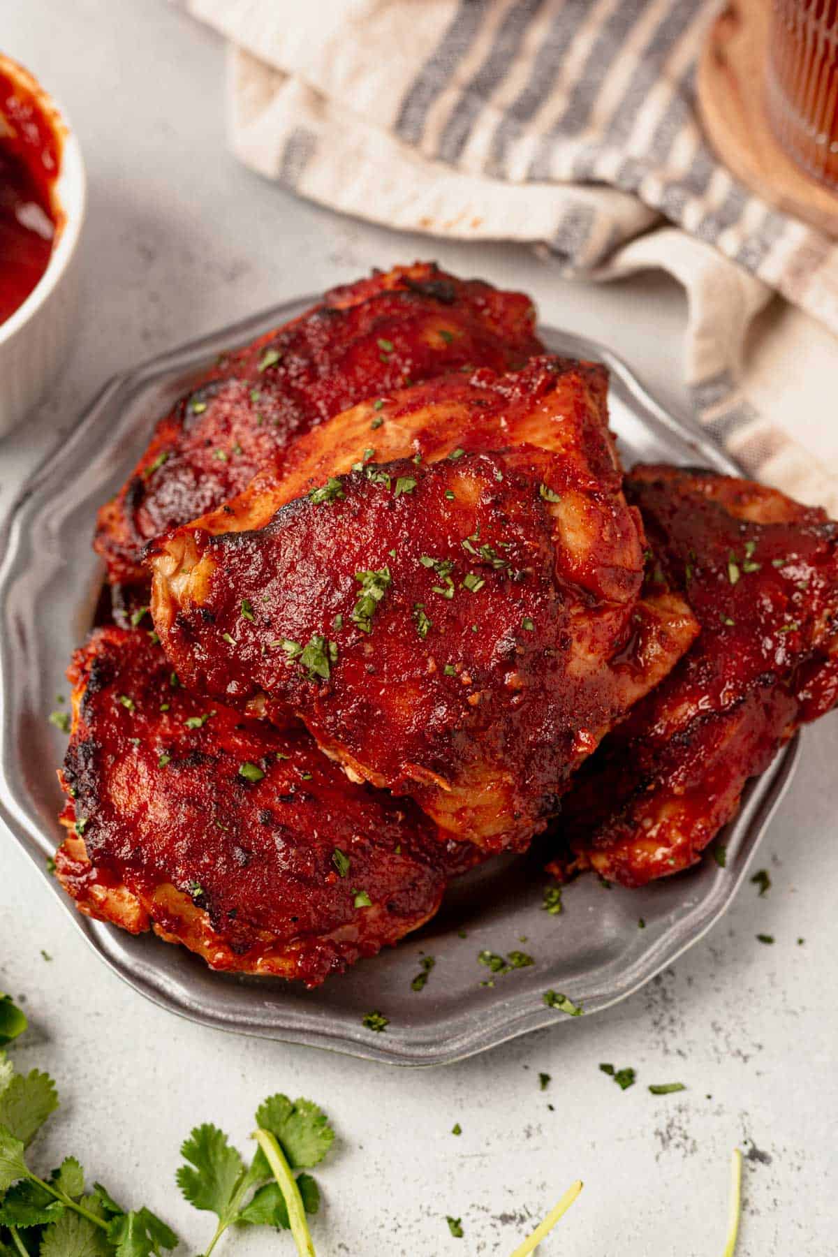 baked bbq chicken thighs on a serving plate