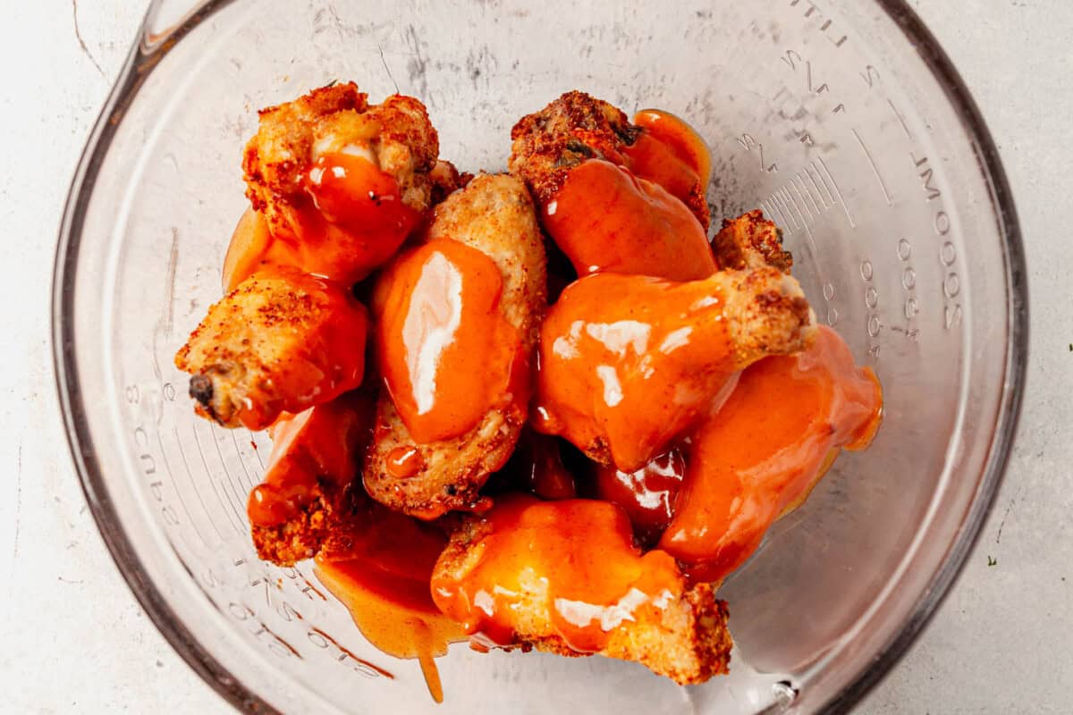 baked chicken wings drizzled with buffalo sauce
