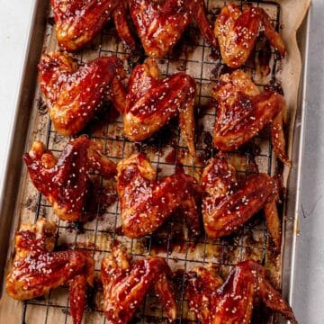 baked chicken wings on a wire rack and baking sheet
