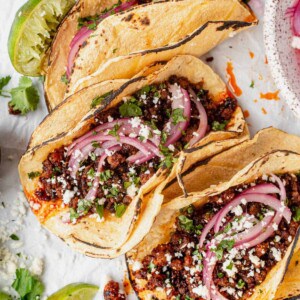 ground pork tacos in corn tortilla with pickled onion and cilantros