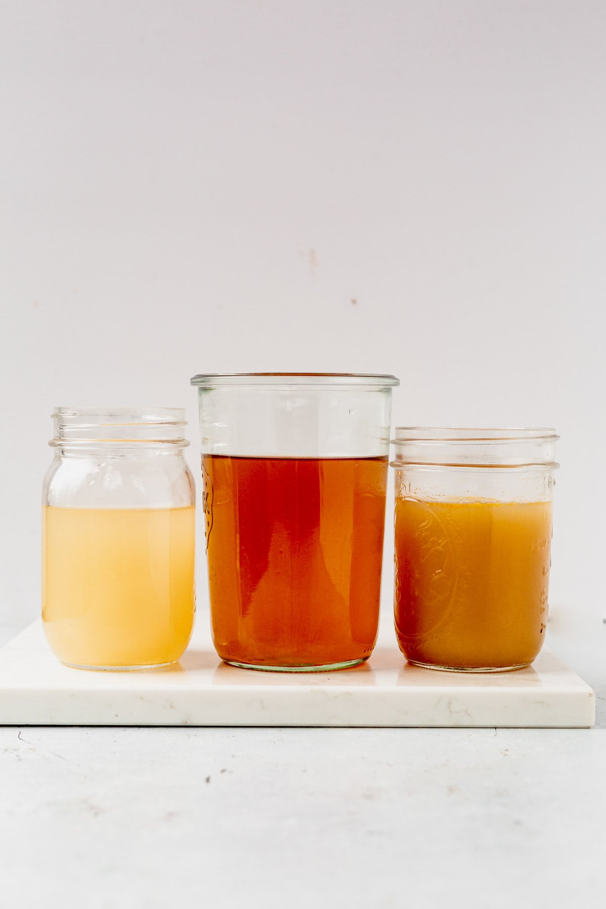 chicken broth and chicken stock in glass jars
