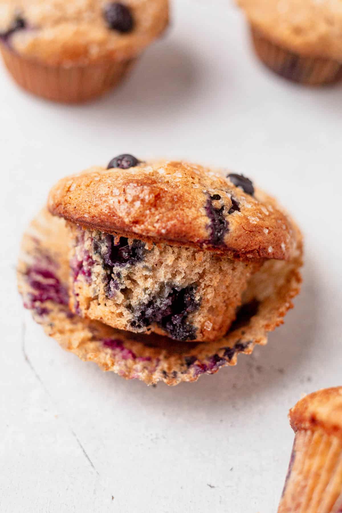 a banana blueberry muffin unwrapped on a table